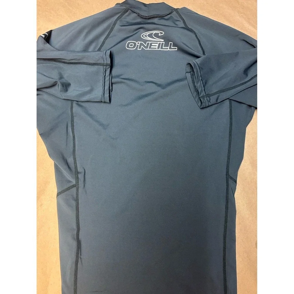 Boys size Medium gray O'Neill rash gaurd with white logo EU.  50+ ultraviolet pr